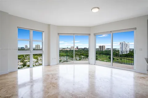 a view of an empty room with wooden floor and garden