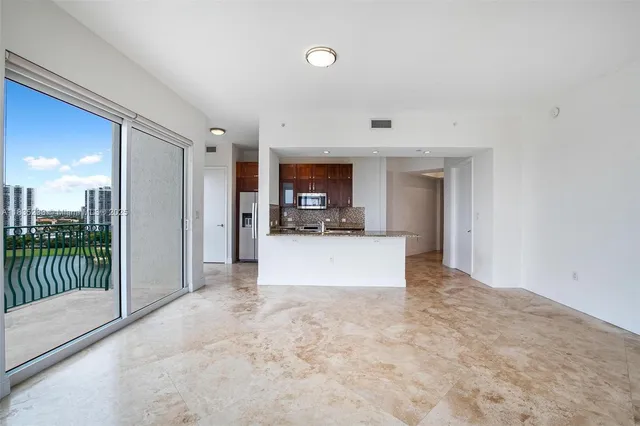 a kitchen with stainless steel appliances a sink a stove and a refrigerator