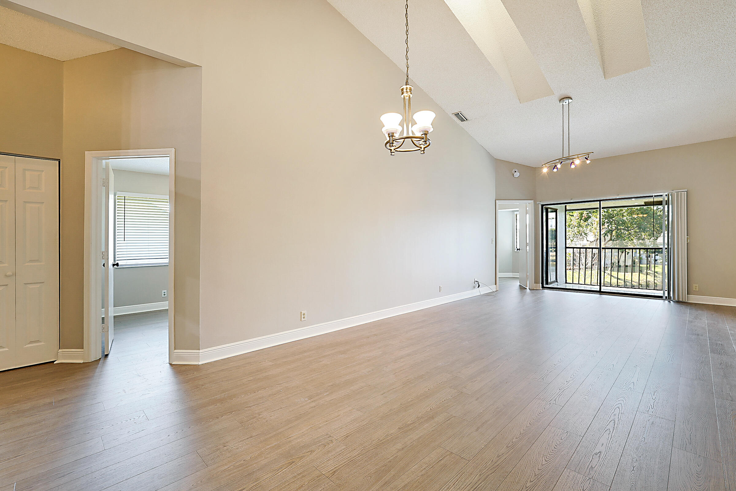 605 Harbour Pointe Way Greenacres, FL 33413 - Photo 12 of 48 an empty room with wooden floor and windows