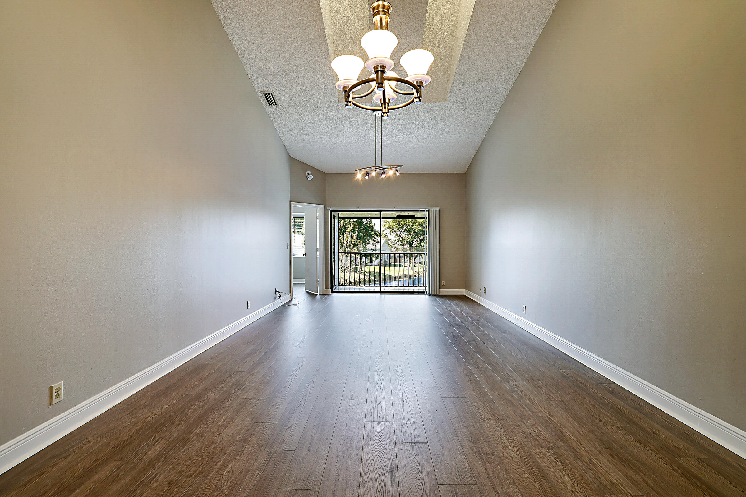 605 Harbour Pointe Way Greenacres, FL 33413 - Photo 15 of 48 a view of an empty room with wooden floor and a window
