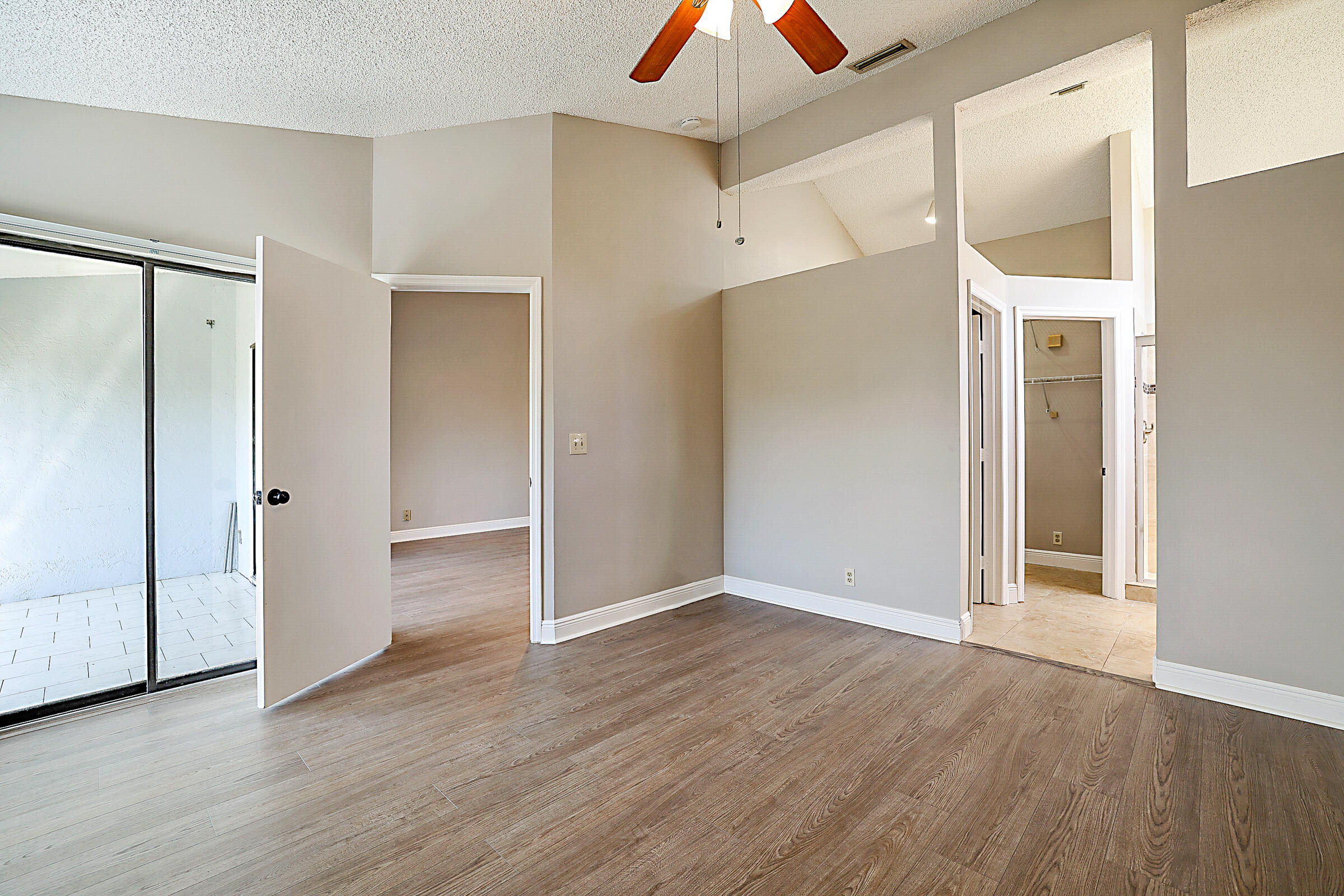 605 Harbour Pointe Way Greenacres, FL 33413 - Photo 20 of 48 an empty room with wooden floor and a ceiling fan