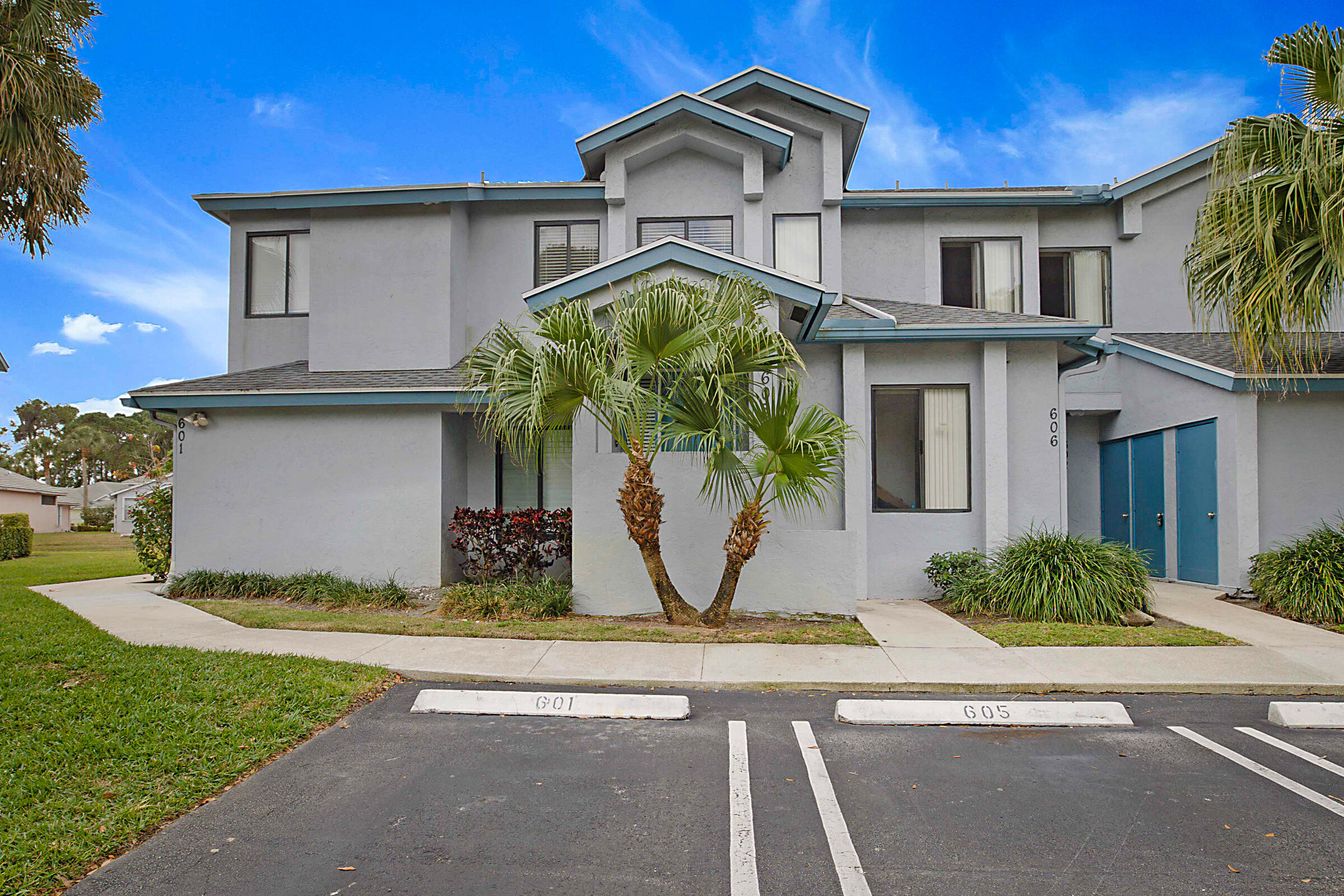 605 Harbour Pointe Way Greenacres, FL 33413 - Photo 2 of 48 a front view of a house with garden