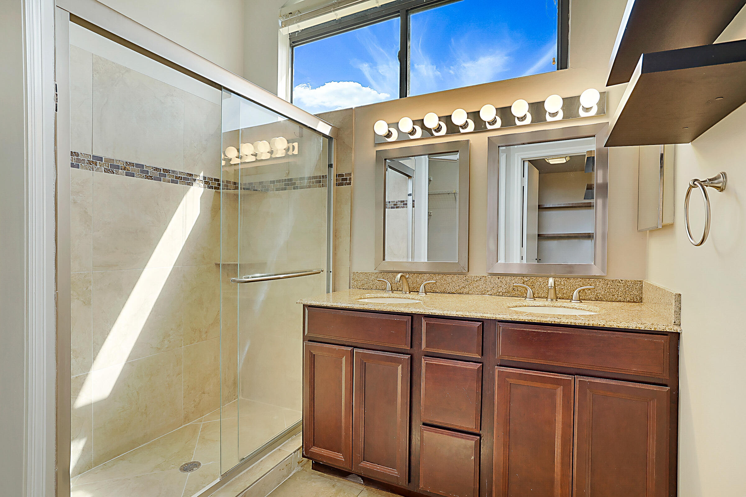 605 Harbour Pointe Way Greenacres, FL 33413 - Photo 21 of 48 a bathroom with a sink a mirror and a shower