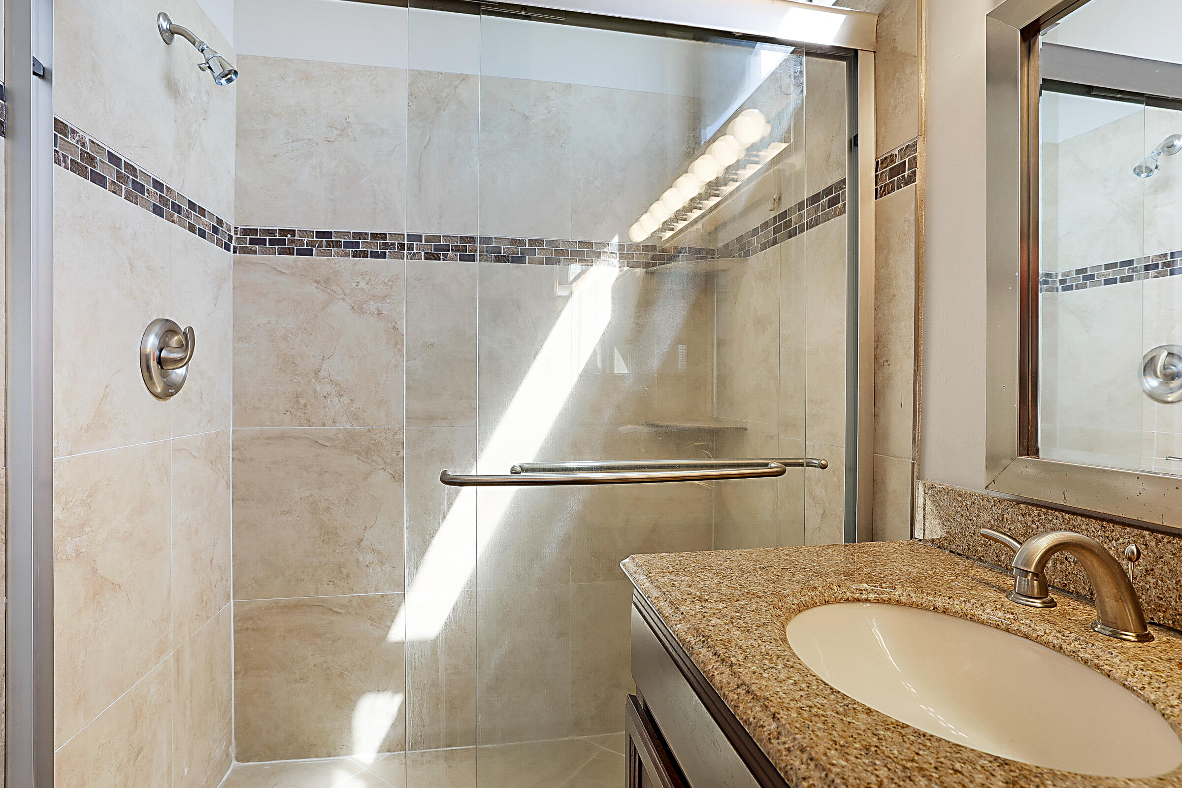 605 Harbour Pointe Way Greenacres, FL 33413 - Photo 22 of 48 a bathroom with a granite countertop shower a mirror and a sink
