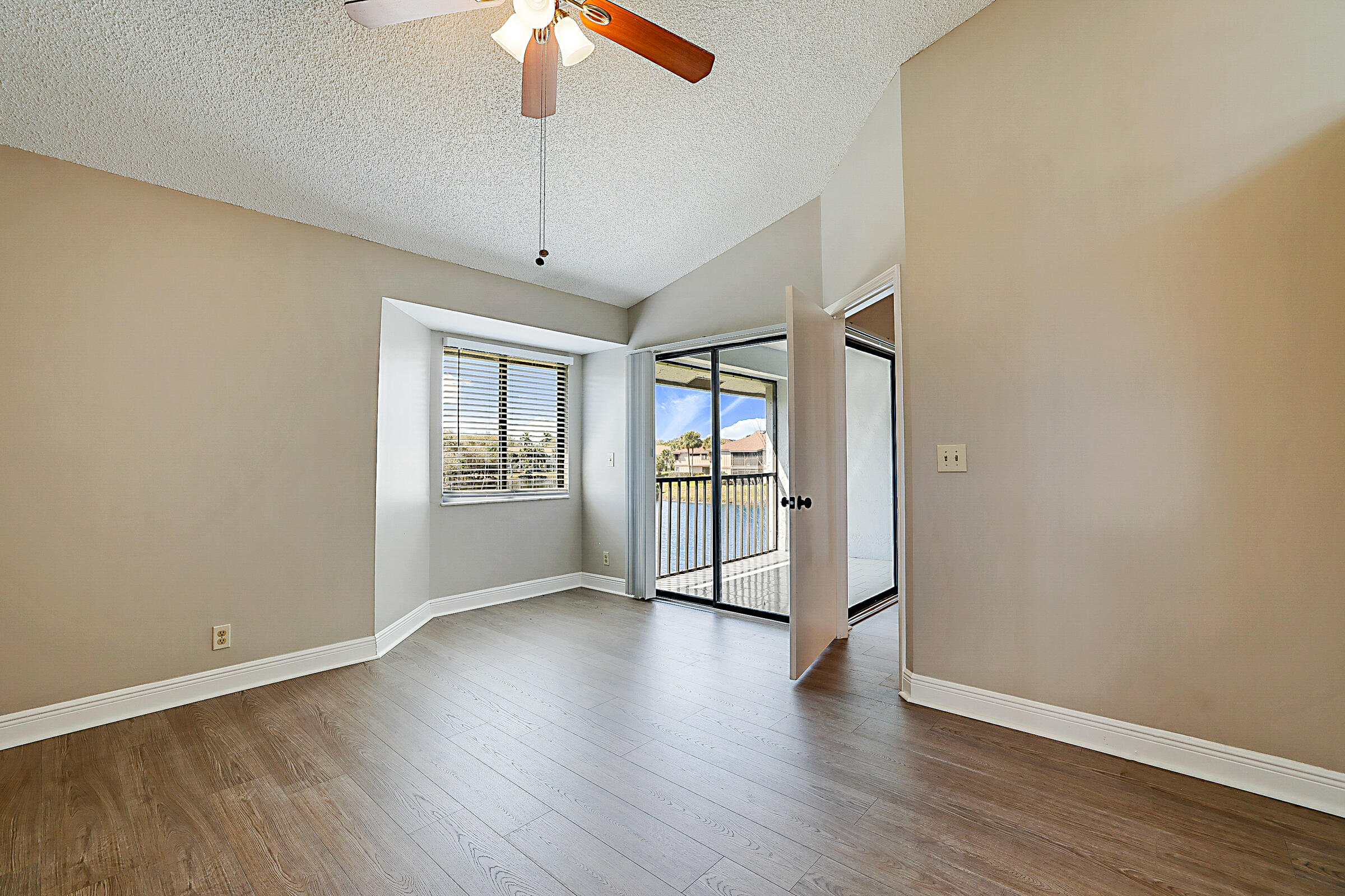 605 Harbour Pointe Way Greenacres, FL 33413 - Photo 25 of 48 a view of an empty room with wooden floor and a window
