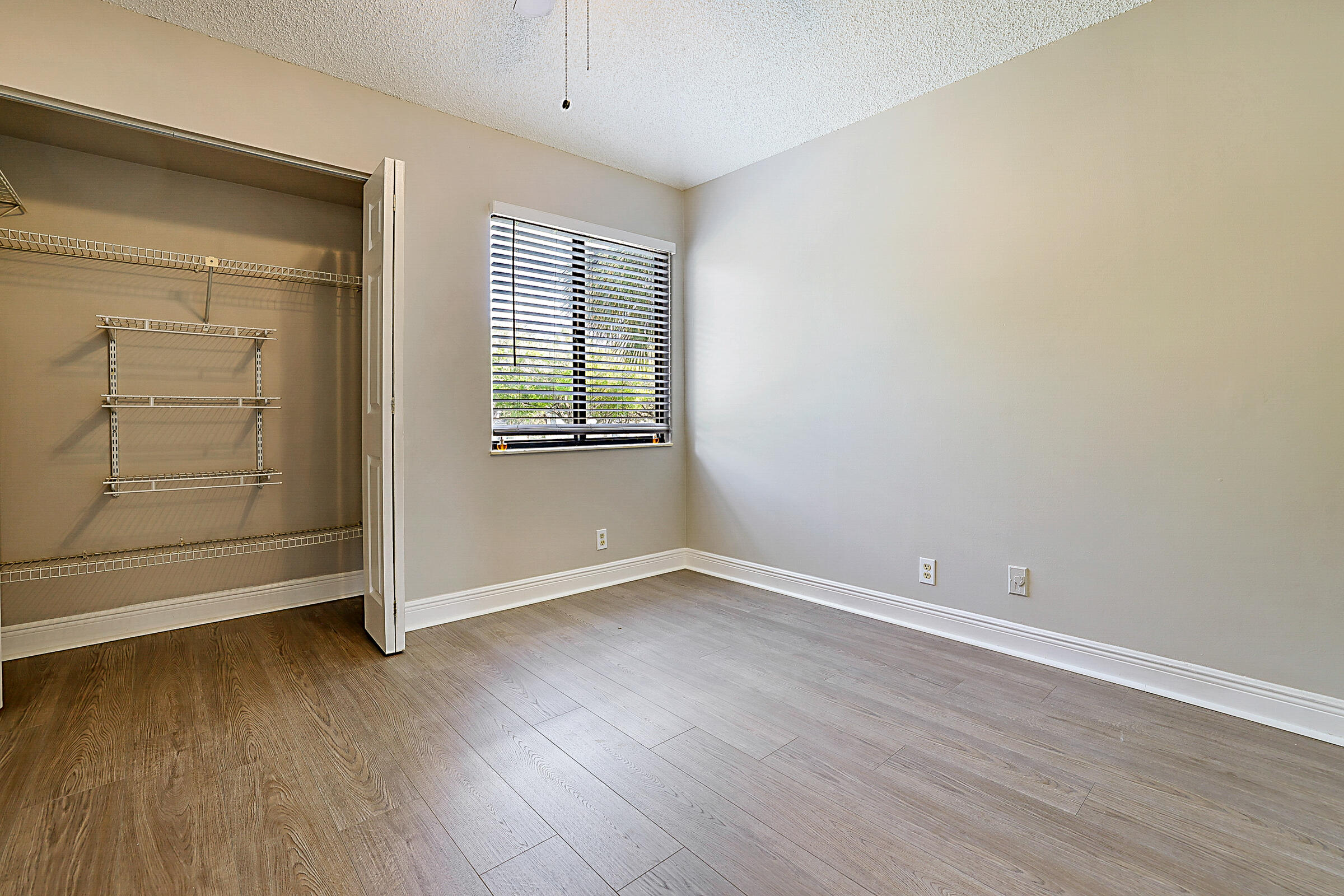 605 Harbour Pointe Way Greenacres, FL 33413 - Photo 31 of 48 an empty room with wooden floor and windows