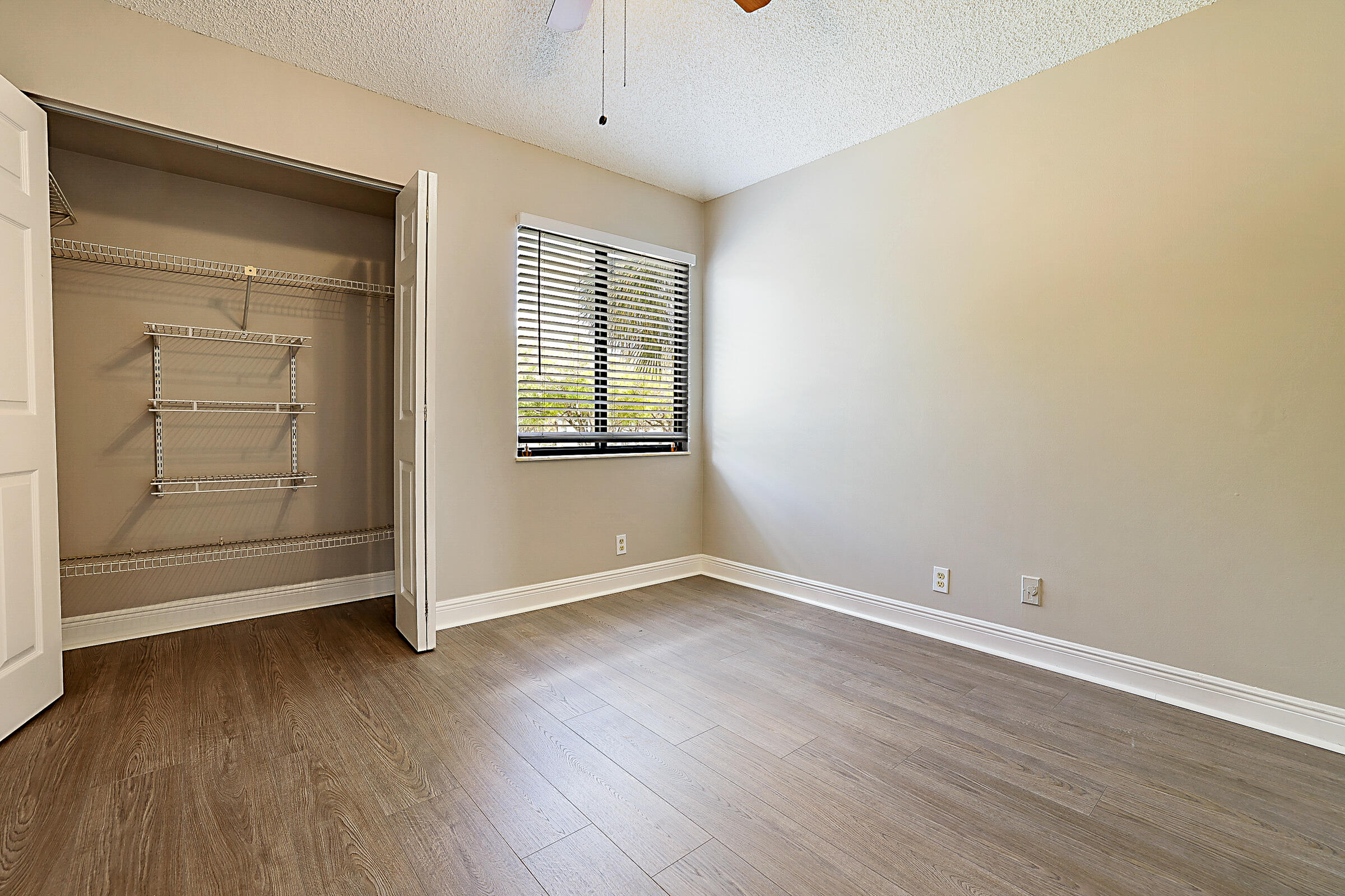 605 Harbour Pointe Way Greenacres, FL 33413 - Photo 32 of 48 an empty room with wooden floor and windows