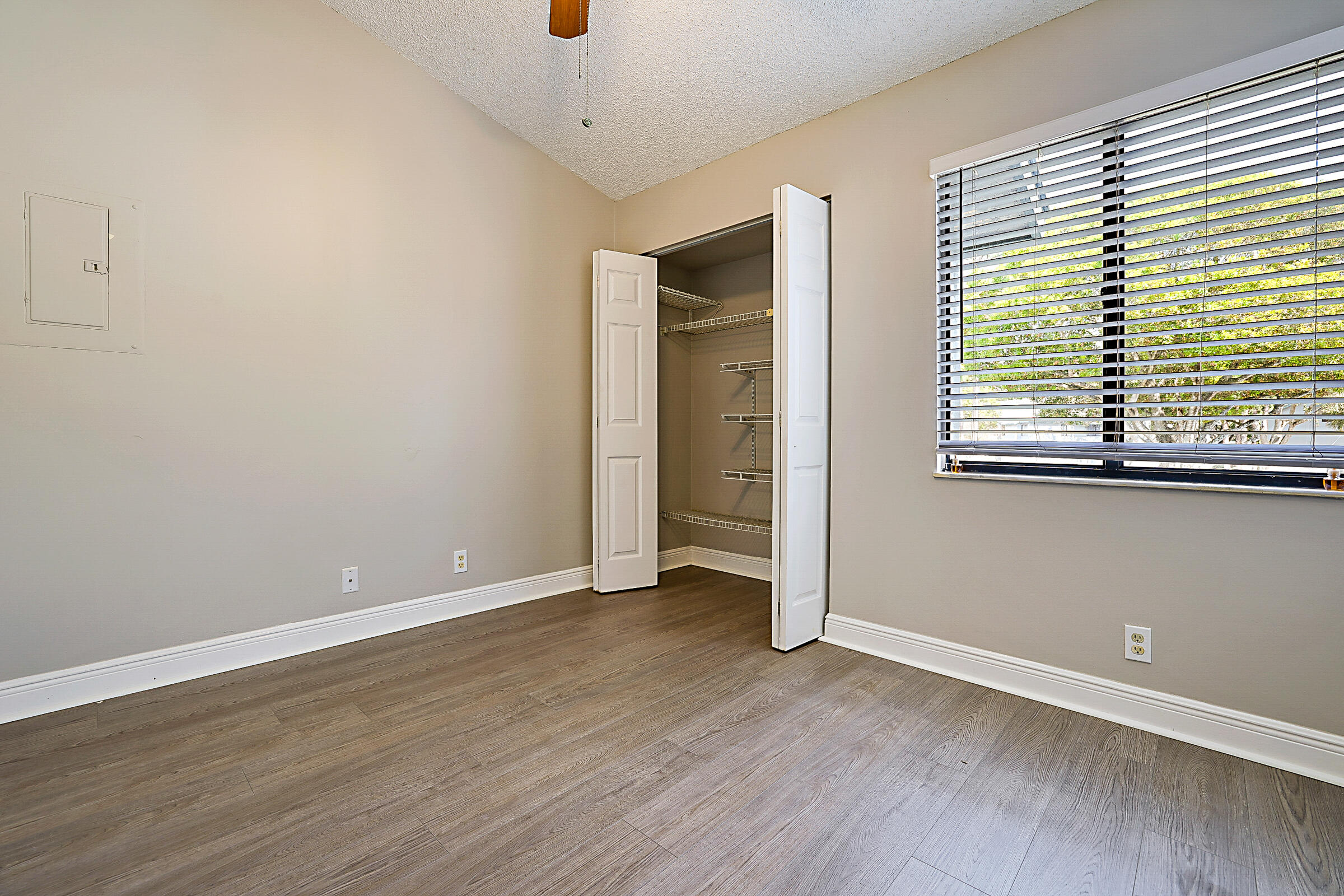 605 Harbour Pointe Way Greenacres, FL 33413 - Photo 35 of 48 an empty room with wooden floor and windows