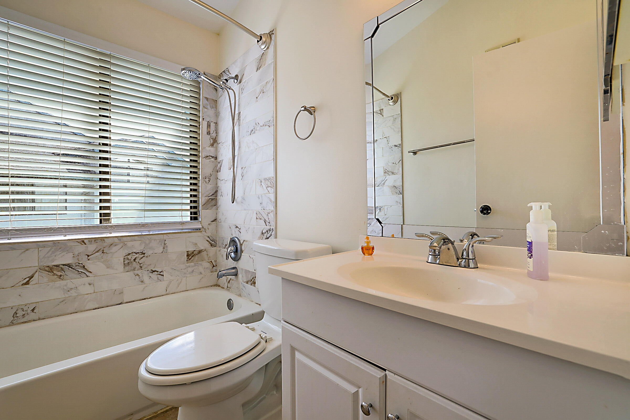 605 Harbour Pointe Way Greenacres, FL 33413 - Photo 36 of 48 a bathroom with a sink a toilet and a bathtub