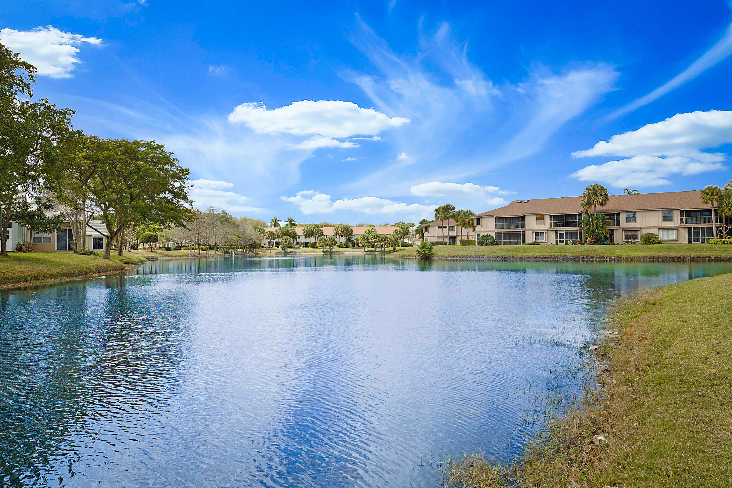 605 Harbour Pointe Way Greenacres, FL 33413 - Photo 40 of 48 a view of a lake with houses