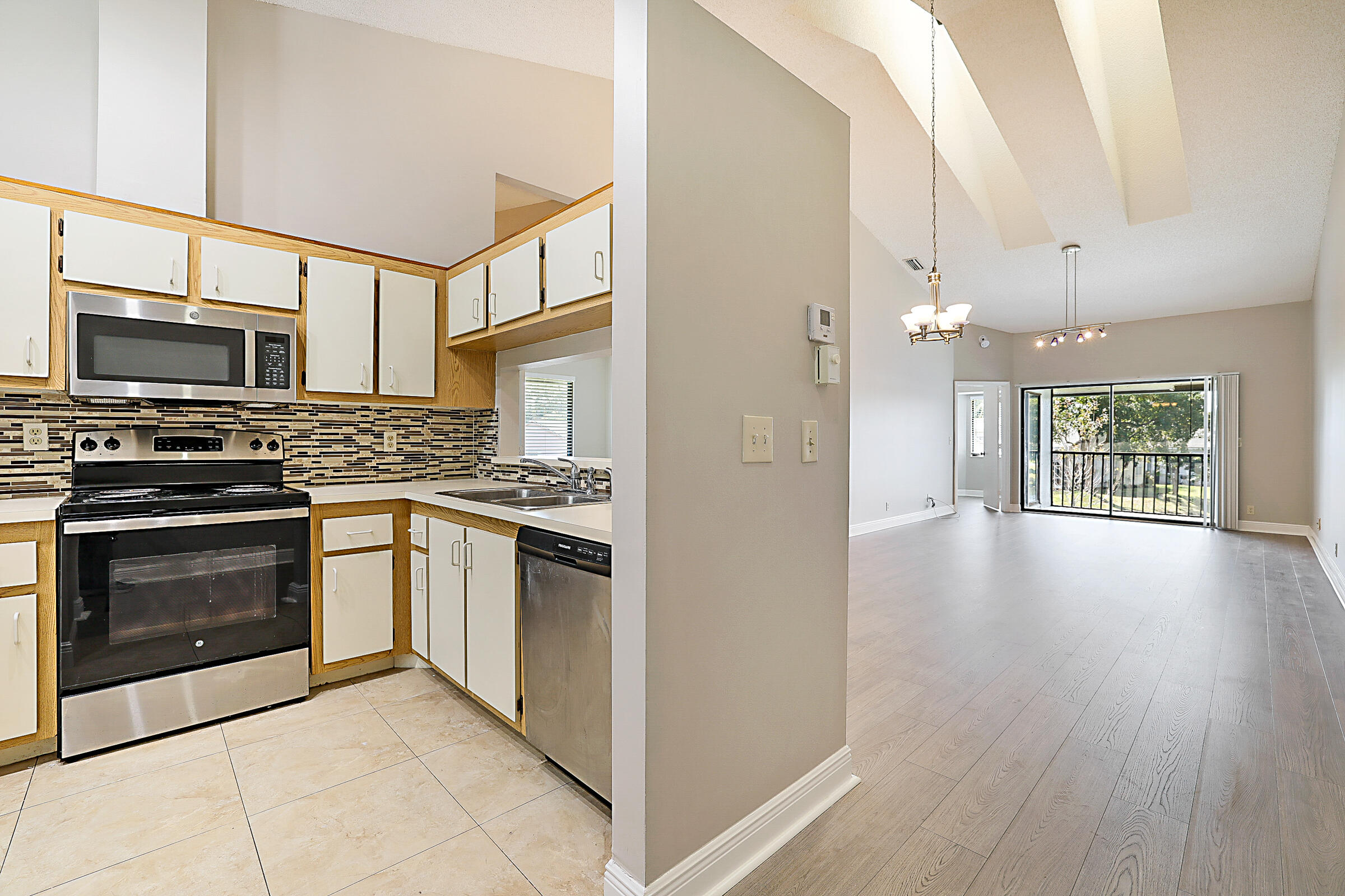 605 Harbour Pointe Way Greenacres, FL 33413 - Photo 5 of 48 a kitchen with stainless steel appliances granite countertop a stove and a refrigerator