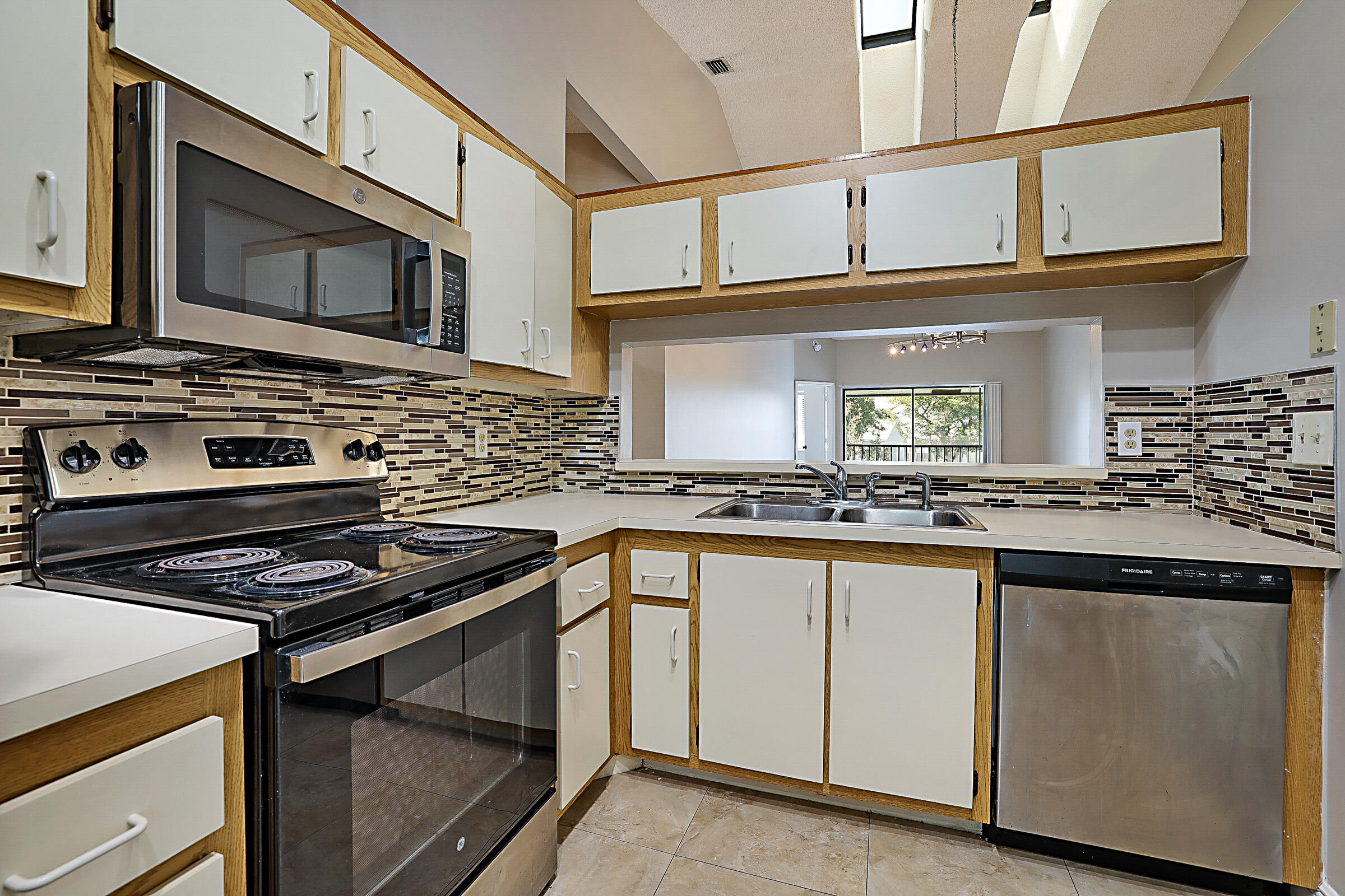 605 Harbour Pointe Way Greenacres, FL 33413 - Photo 7 of 48 a kitchen with stainless steel appliances granite countertop a stove and a microwave