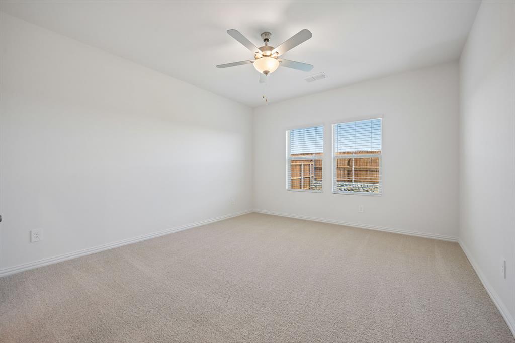 1705 Arches Road Anna, TX 75409 - Photo 20 of 33 an empty room with a ceiling fan and window