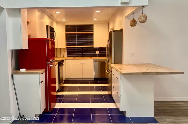 a kitchen with a sink and a refrigerator