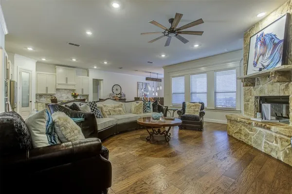 a living room with furniture kitchen view and a fireplace