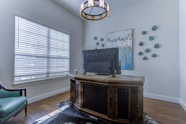 a room with painting on the wall and a window