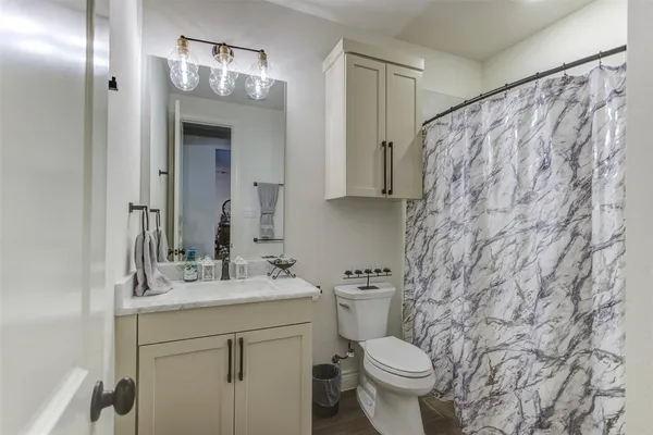 a bathroom with a sink toilet and shower