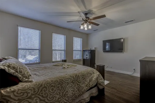 a bedroom with a bed and a flat screen tv