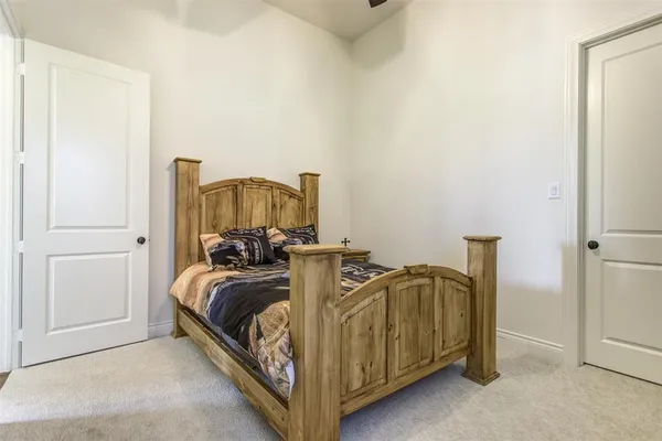 a bed sitting in a bedroom next to a bathroom