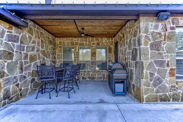 a view of a chairs and table in patio