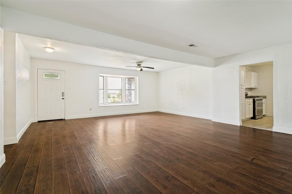 1904 Old Kirk Road Bedford, TX 76022 - Photo 6 of 25 an empty room with wooden floor and windows