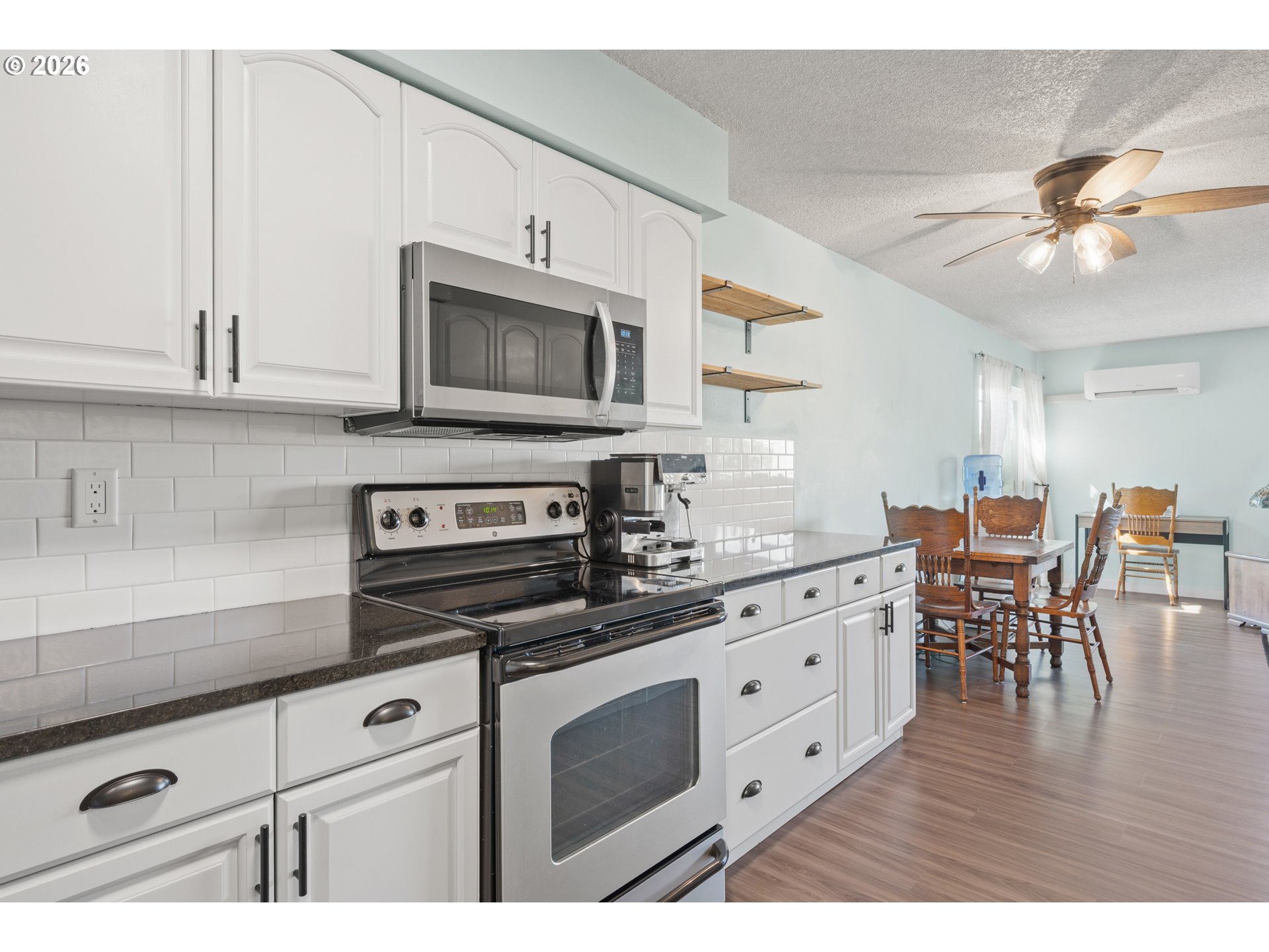 2727 Gateway Street, Unit 18 Springfield, OR 97477 - Photo 13 of 34 a kitchen with stainless steel appliances white cabinets sink and wooden floor