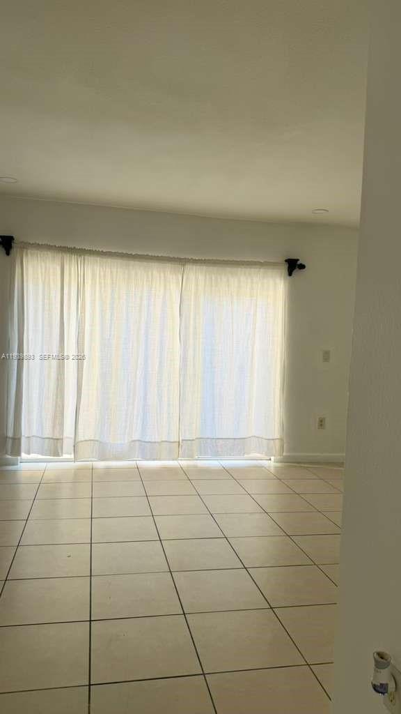 1555 Northeast 33rd Road, Unit 1012 Homestead, FL 33033 - Photo 12 of 54 a view of an empty room and window