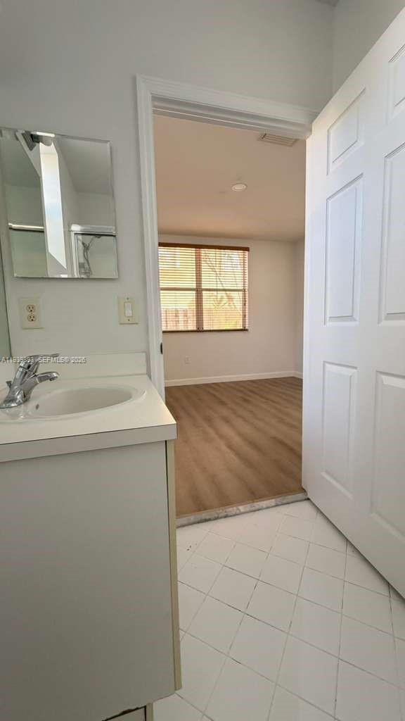 1555 Northeast 33rd Road, Unit 1012 Homestead, FL 33033 - Photo 23 of 54 a bathroom with a sink a vanity and a mirror