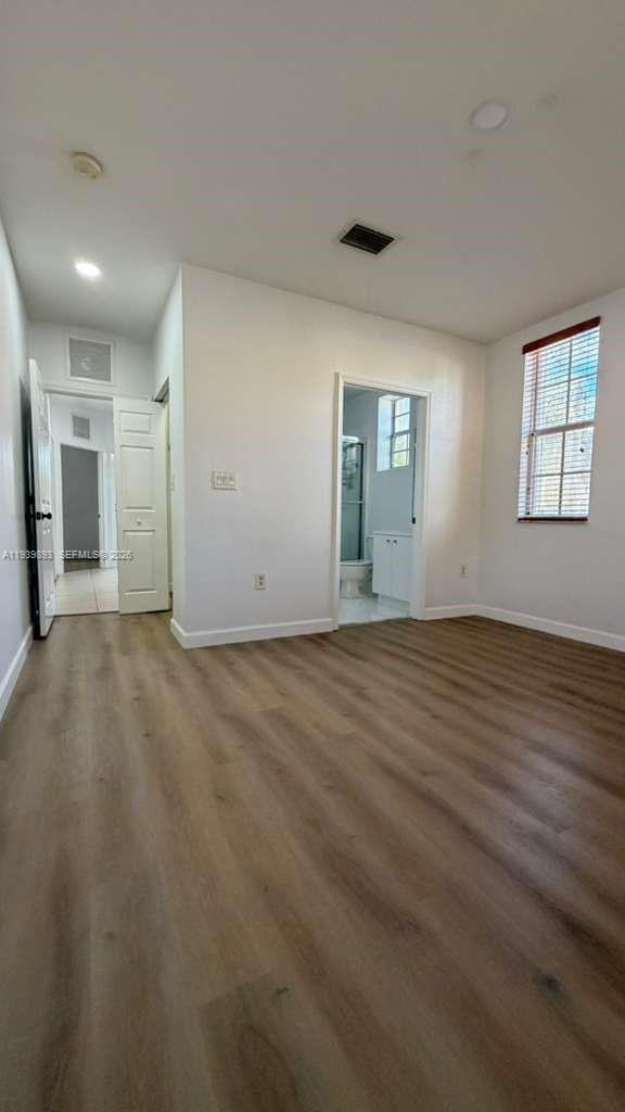 1555 Northeast 33rd Road, Unit 1012 Homestead, FL 33033 - Photo 27 of 54 an empty room with wooden floor and windows