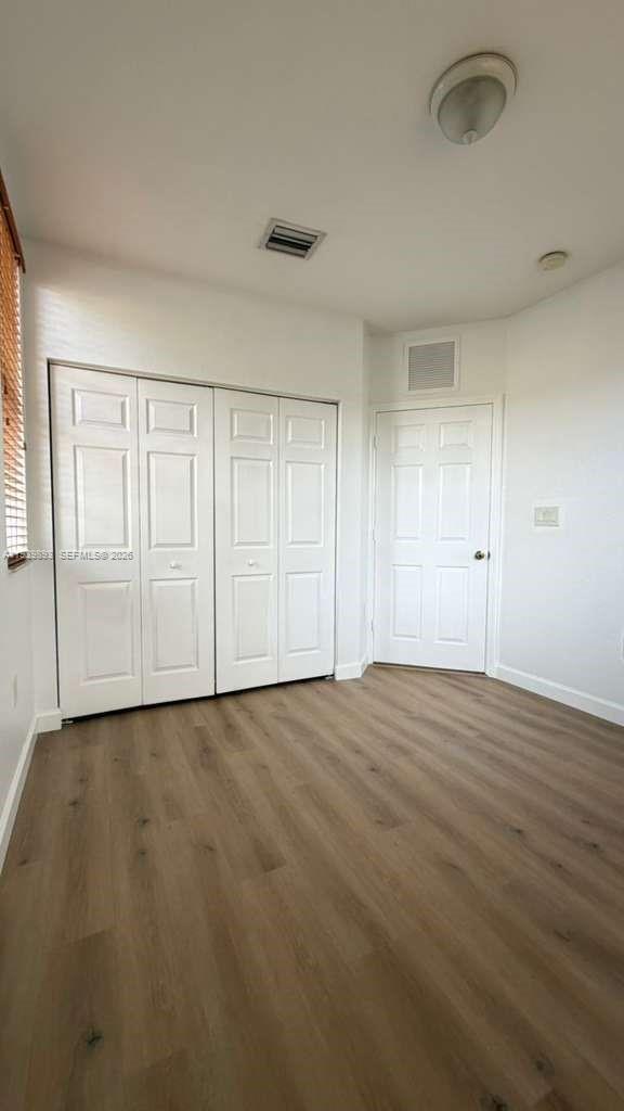 1555 Northeast 33rd Road, Unit 1012 Homestead, FL 33033 - Photo 37 of 54 wooden floor in an empty room