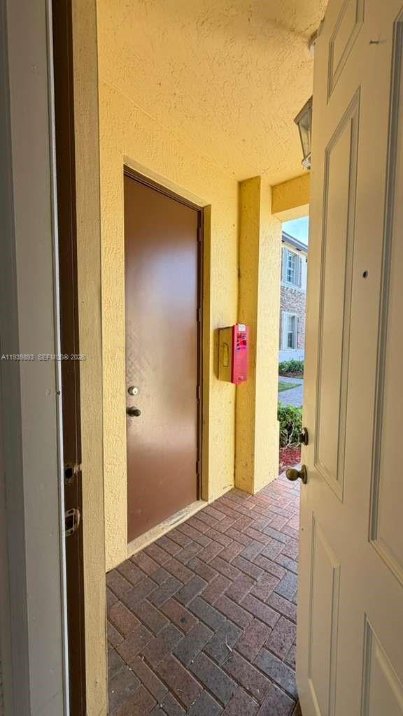 1555 Northeast 33rd Road, Unit 1012 Homestead, FL 33033 - Photo 4 of 54 a view of a bathroom from a hallway