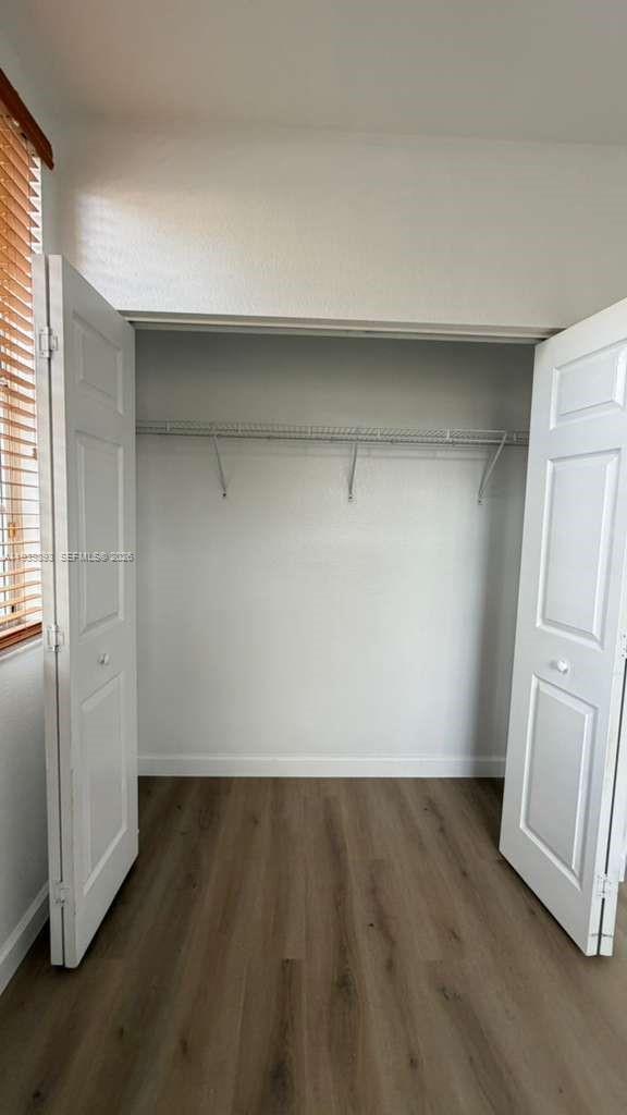 1555 Northeast 33rd Road, Unit 1012 Homestead, FL 33033 - Photo 41 of 54 an empty room with wooden floor and cabinet