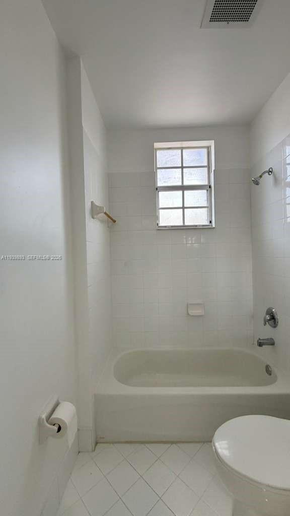 1555 Northeast 33rd Road, Unit 1012 Homestead, FL 33033 - Photo 44 of 54 a white bath tub sitting next to a window