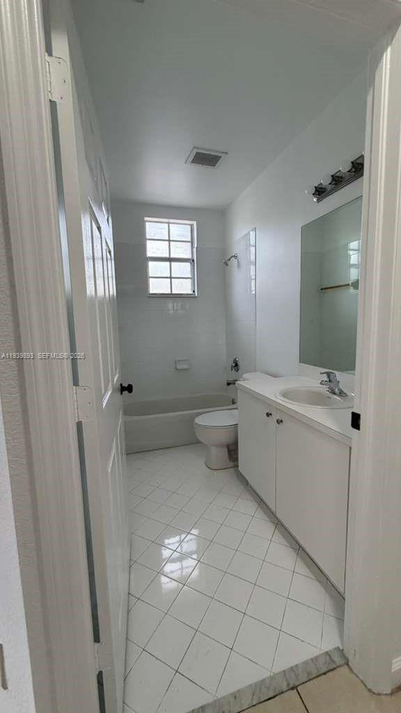 1555 Northeast 33rd Road, Unit 1012 Homestead, FL 33033 - Photo 47 of 54 a bathroom with a sink a toilet and mirror