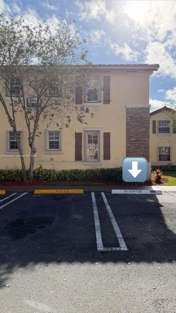 1555 Northeast 33rd Road, Unit 1012 Homestead, FL 33033 - Photo 52 of 54 a front view of a house with a yard