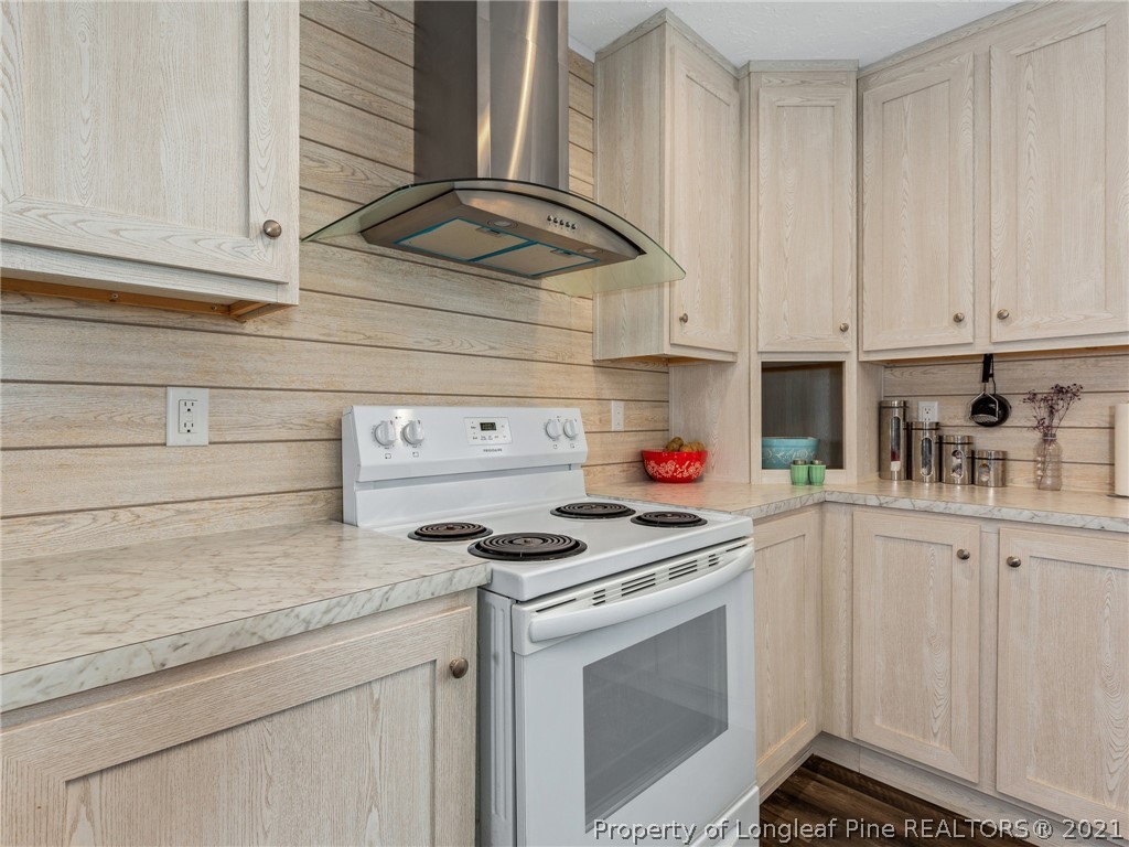 753 Mitchell Loop Road Roseboro, NC 28382 - Photo 12 of 30 a kitchen with granite countertop white cabinets and white appliances