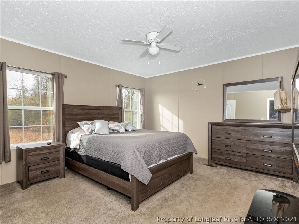 753 Mitchell Loop Road Roseboro, NC 28382 - Photo 16 of 30 a bedroom with a bed a window and closet