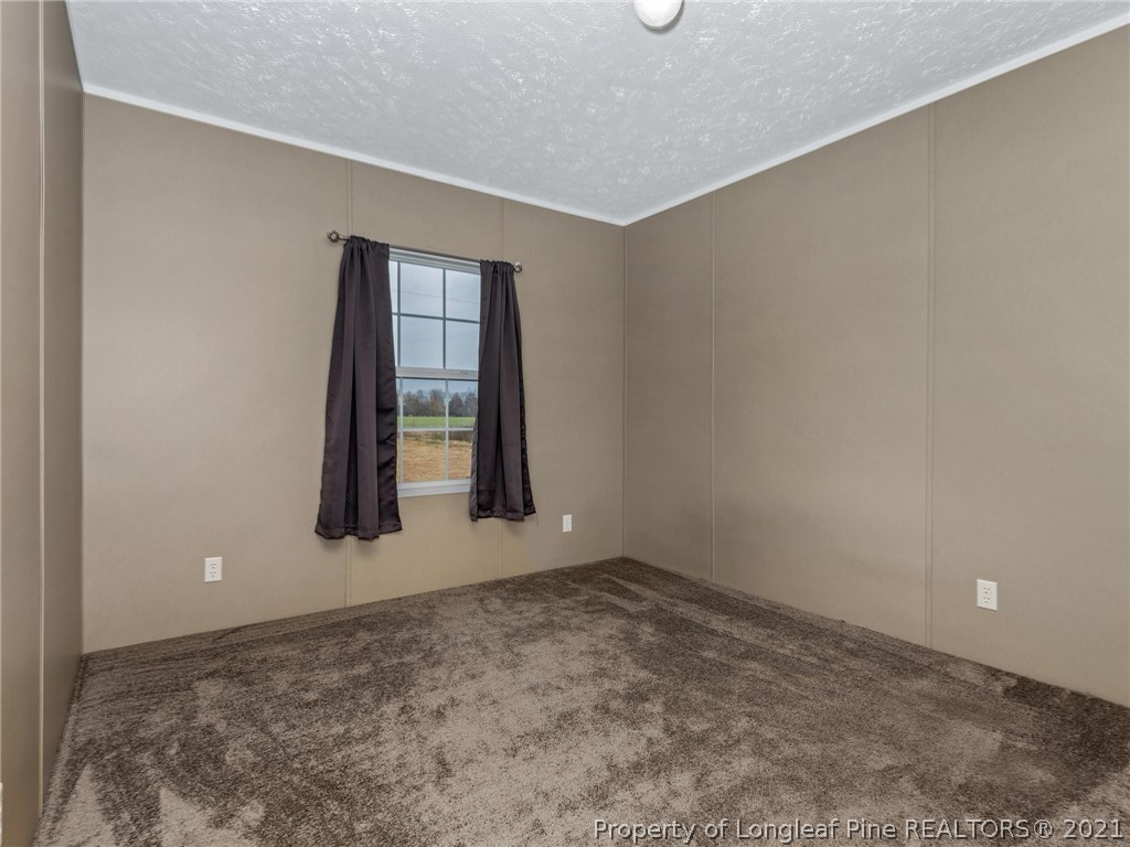 753 Mitchell Loop Road Roseboro, NC 28382 - Photo 21 of 30 an empty room with a empty space and window