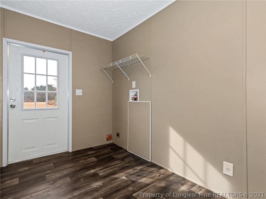 753 Mitchell Loop Road Roseboro, NC 28382 - Photo 27 of 30 a view of an empty room with wooden floor and a window
