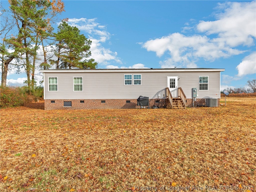 753 Mitchell Loop Road Roseboro, NC 28382 - Photo 30 of 30 a view of a house with backyard and sitting area