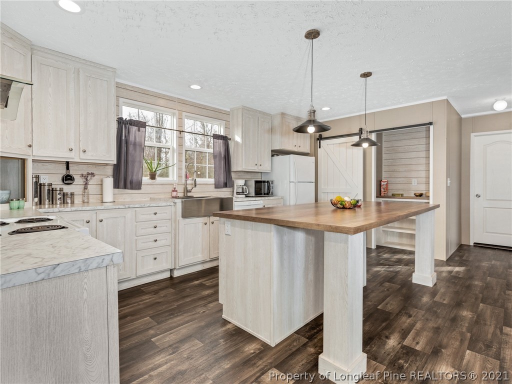 753 Mitchell Loop Road Roseboro, NC 28382 - Photo 9 of 30 a kitchen with white cabinets and white appliances