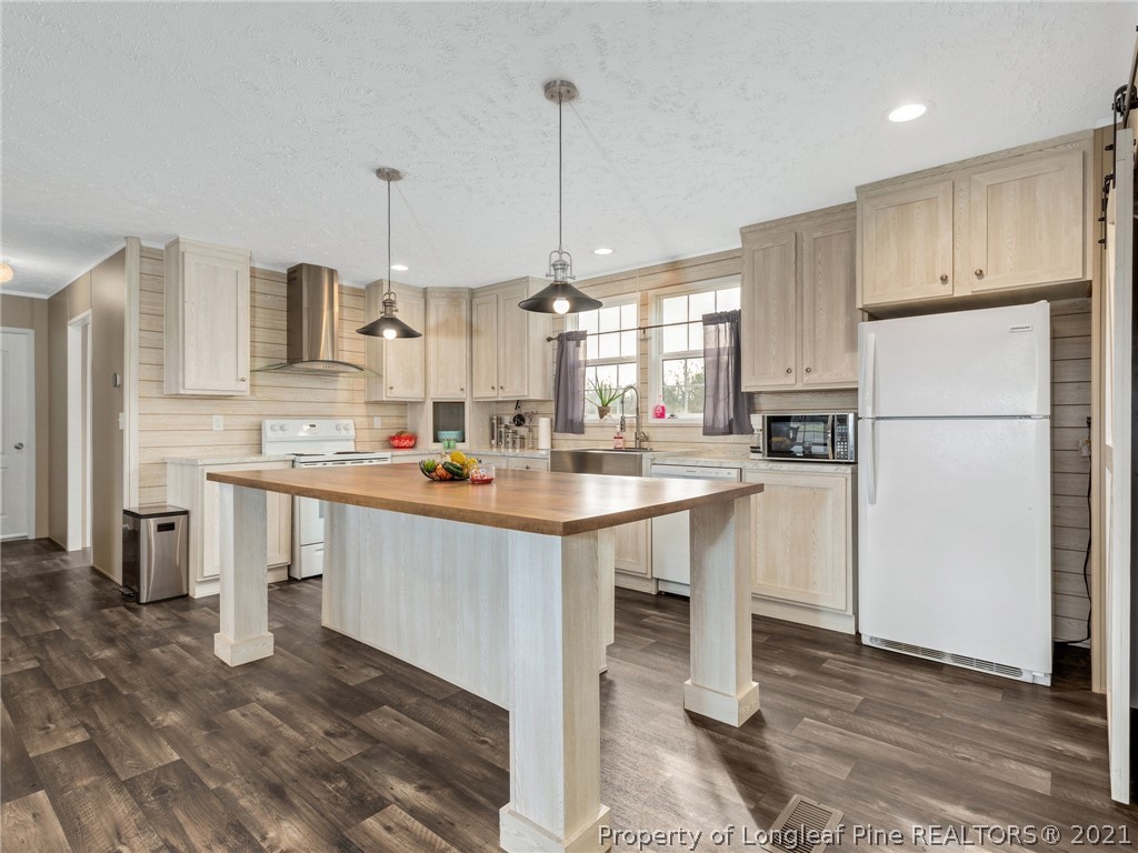 753 Mitchell Loop Road Roseboro, NC 28382 - Photo 10 of 30 a kitchen with white cabinets and stainless steel appliances