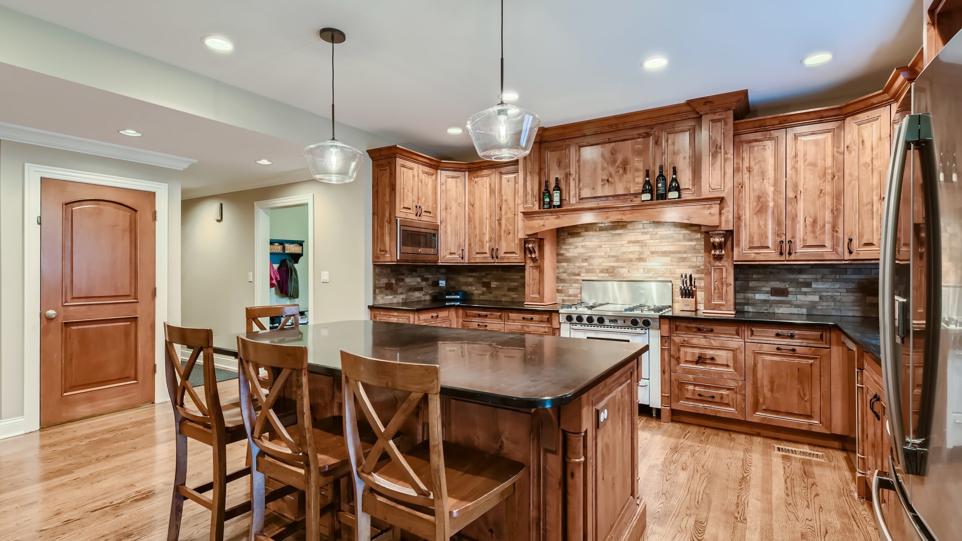 820 Hansen Place Park Ridge, IL 60068 - Photo 7 of 38 a kitchen with stainless steel appliances granite countertop a stove top oven a refrigerator a sink and dishwasher with wooden floor