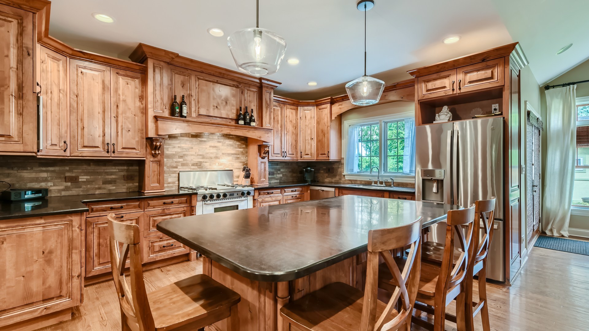 820 Hansen Place Park Ridge, IL 60068 - Photo 8 of 38 a kitchen with stainless steel appliances granite countertop a stove a refrigerator a kitchen island a sink a stove and a cabinets