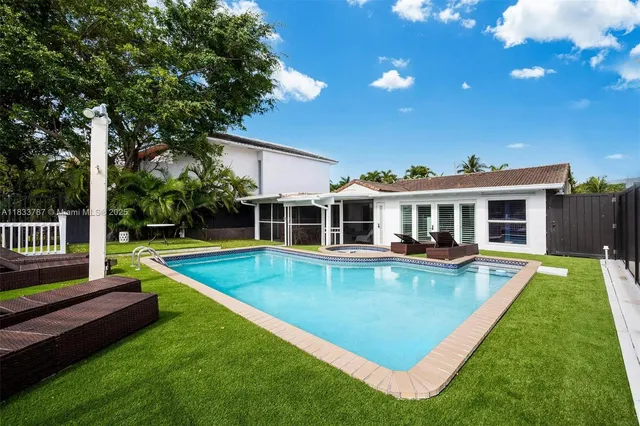 a view of a house with swimming pool and porch with furniture