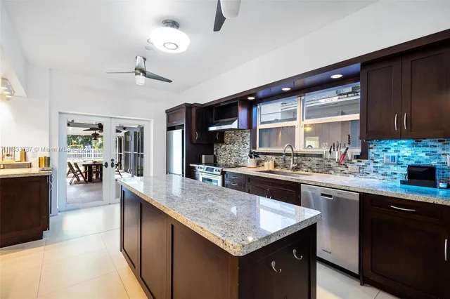 a kitchen with a table chairs stove and cabinets