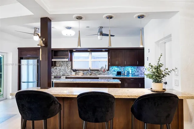 a dining room with furniture and chandelier