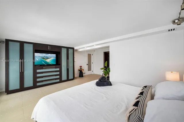 a bedroom with a bed and a chair