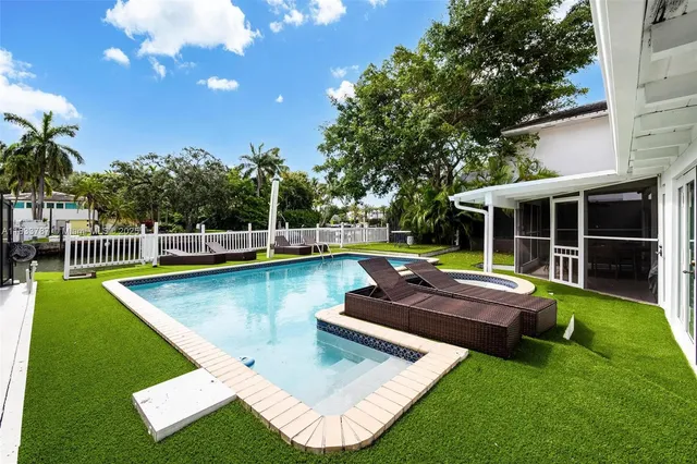an aerial view of residential houses with outdoor space and lake view