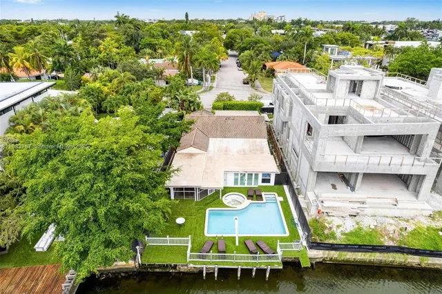 an aerial view of residential houses with outdoor space